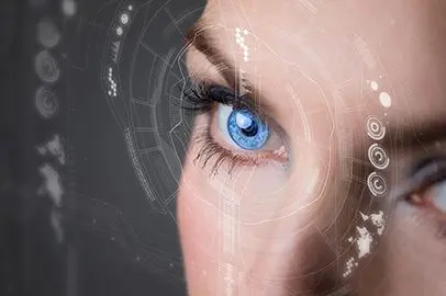 A woman 's eye with blue eyes and a web pattern.