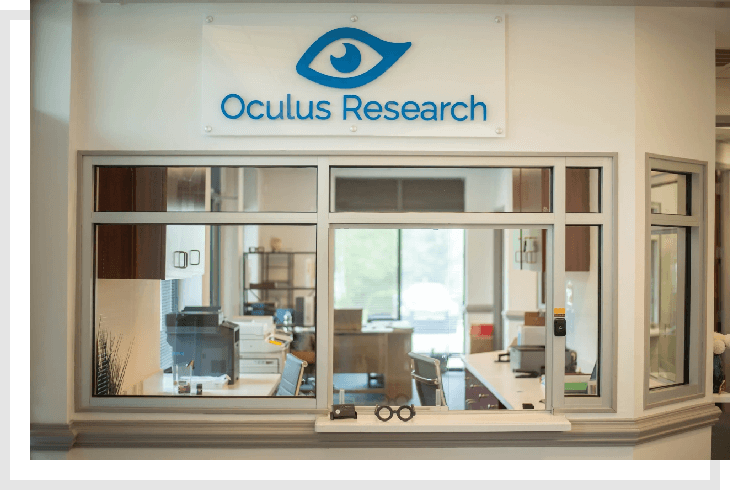 A sign for oculus research in front of a building.
