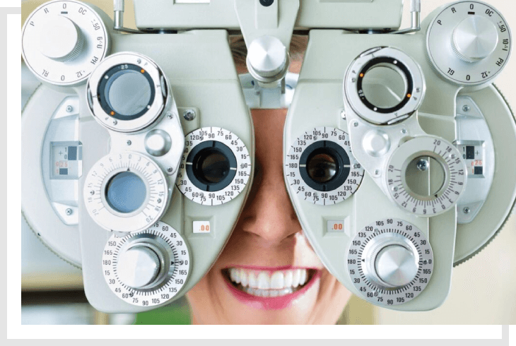 A woman is looking through the lens of an eye test.