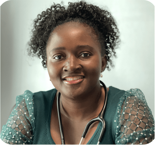 Smiling woman with stethoscope and curly hair.